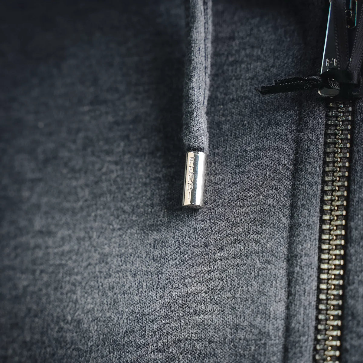 Fendi heather gray hoodie with metal zipper pull and branded label near side seam