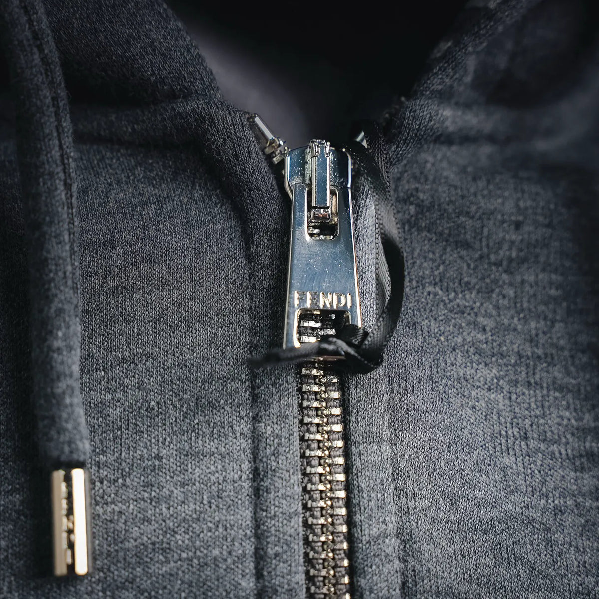 Fendi heather gray hoodie zipper close-up with chunky metal teeth and pull tab