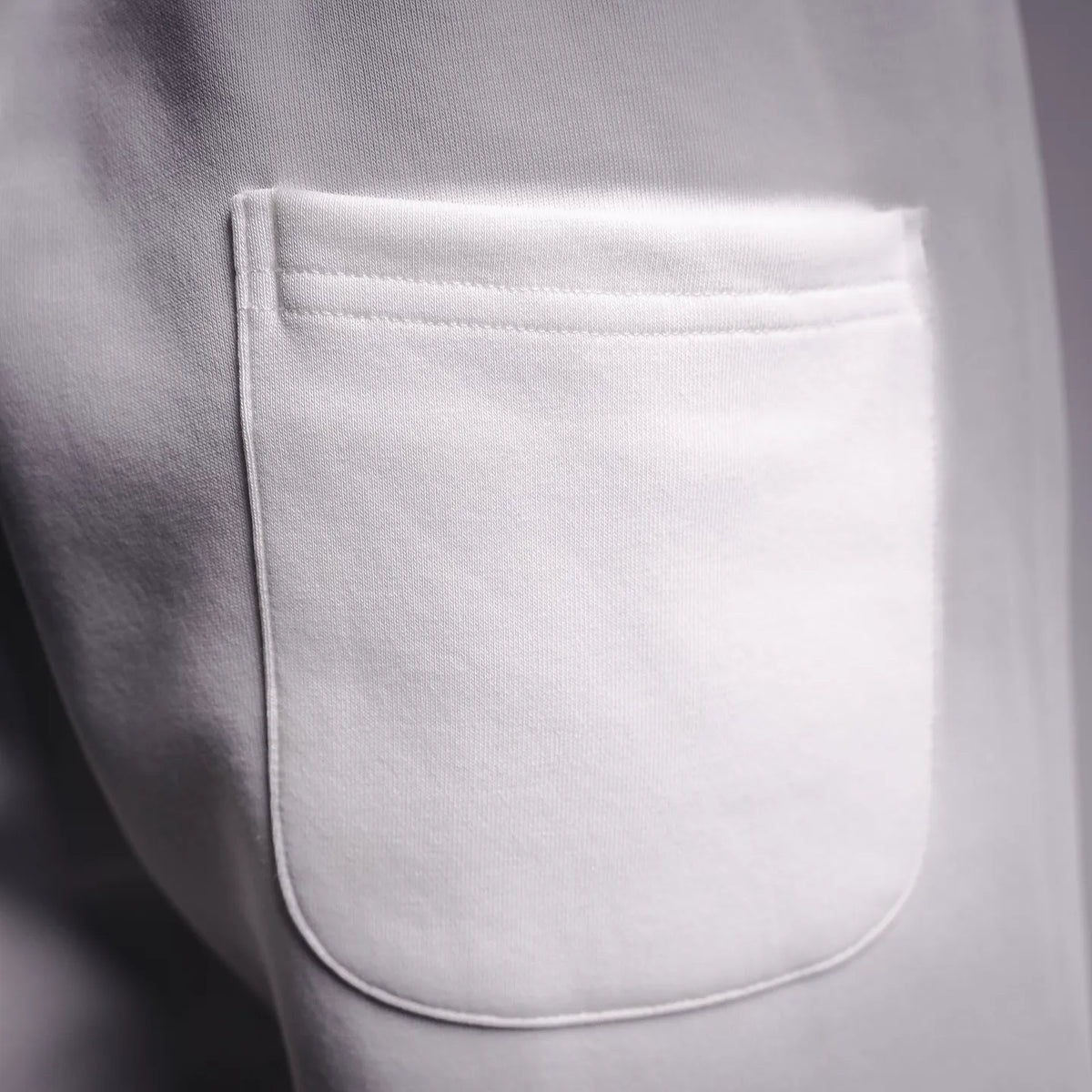 White shorts with curved side pocket opening detail