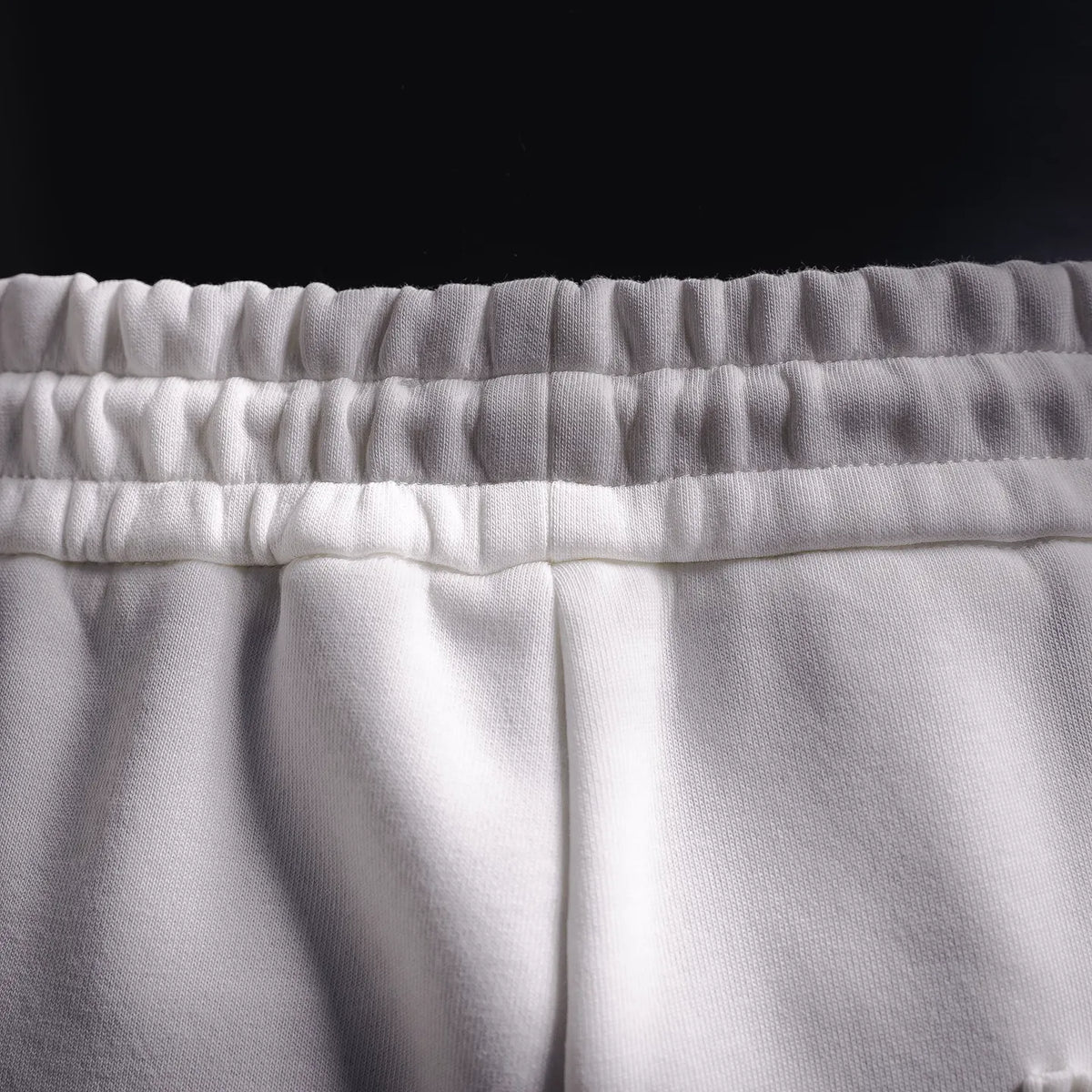 White elastic waistband shorts with gathered waistband texture