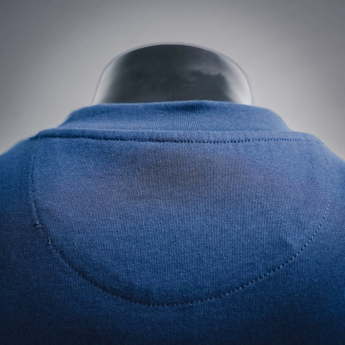 Blue T-shirt back yoke seam under crewneck