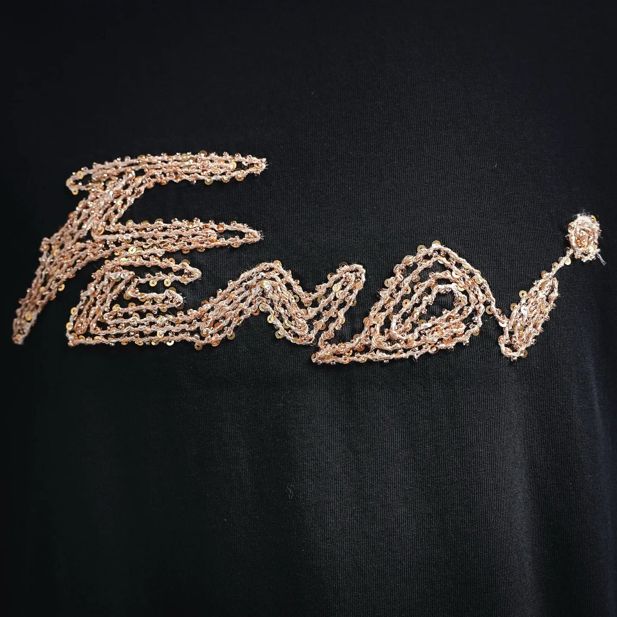 Fendi gold logo embroidery detail on black T-shirt