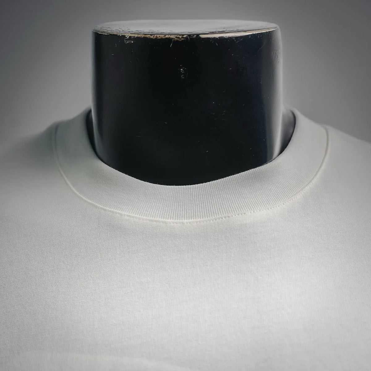White T-shirt crew neckline ribbed collar close-up