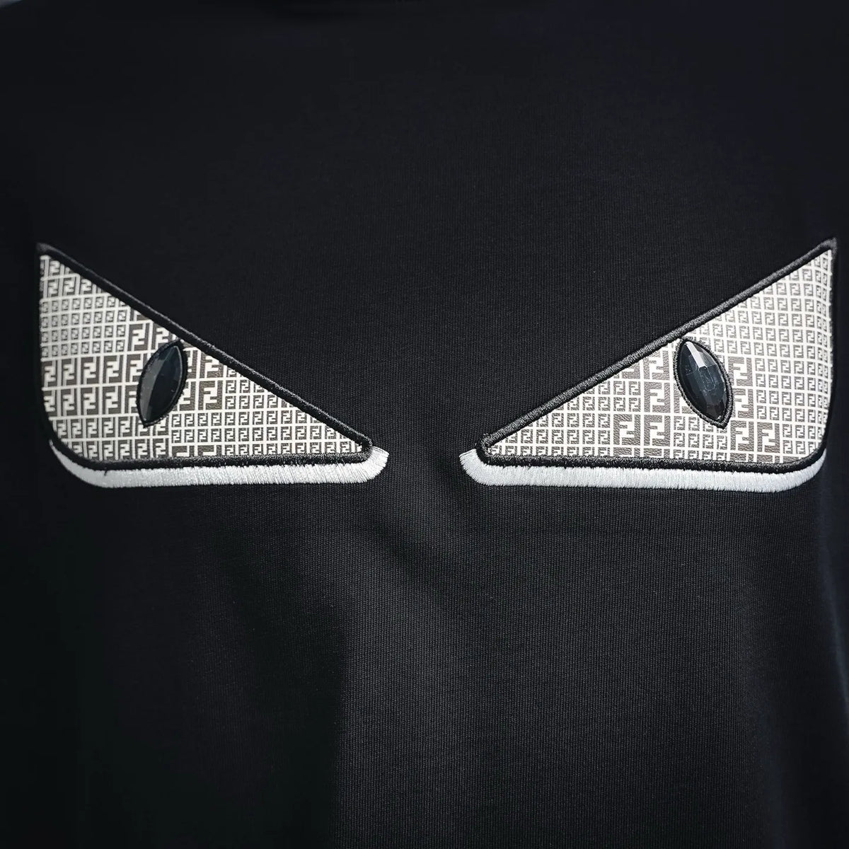Black T-shirt with white FF logo patch detail near the neckline