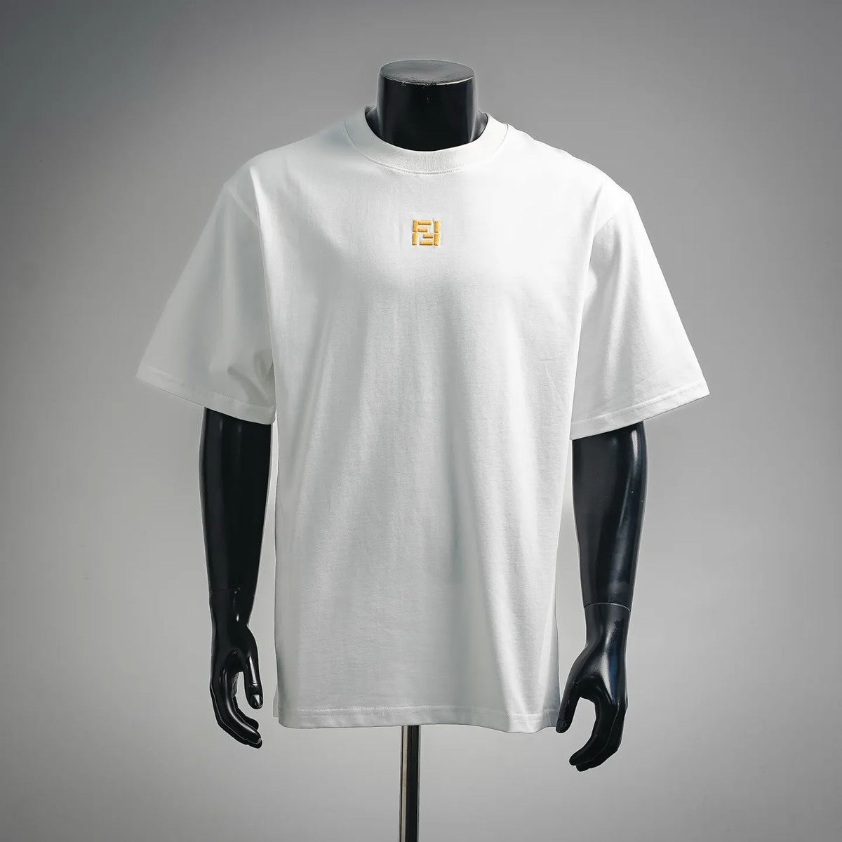 White short-sleeve T-shirt with small yellow embroidered logo at chest