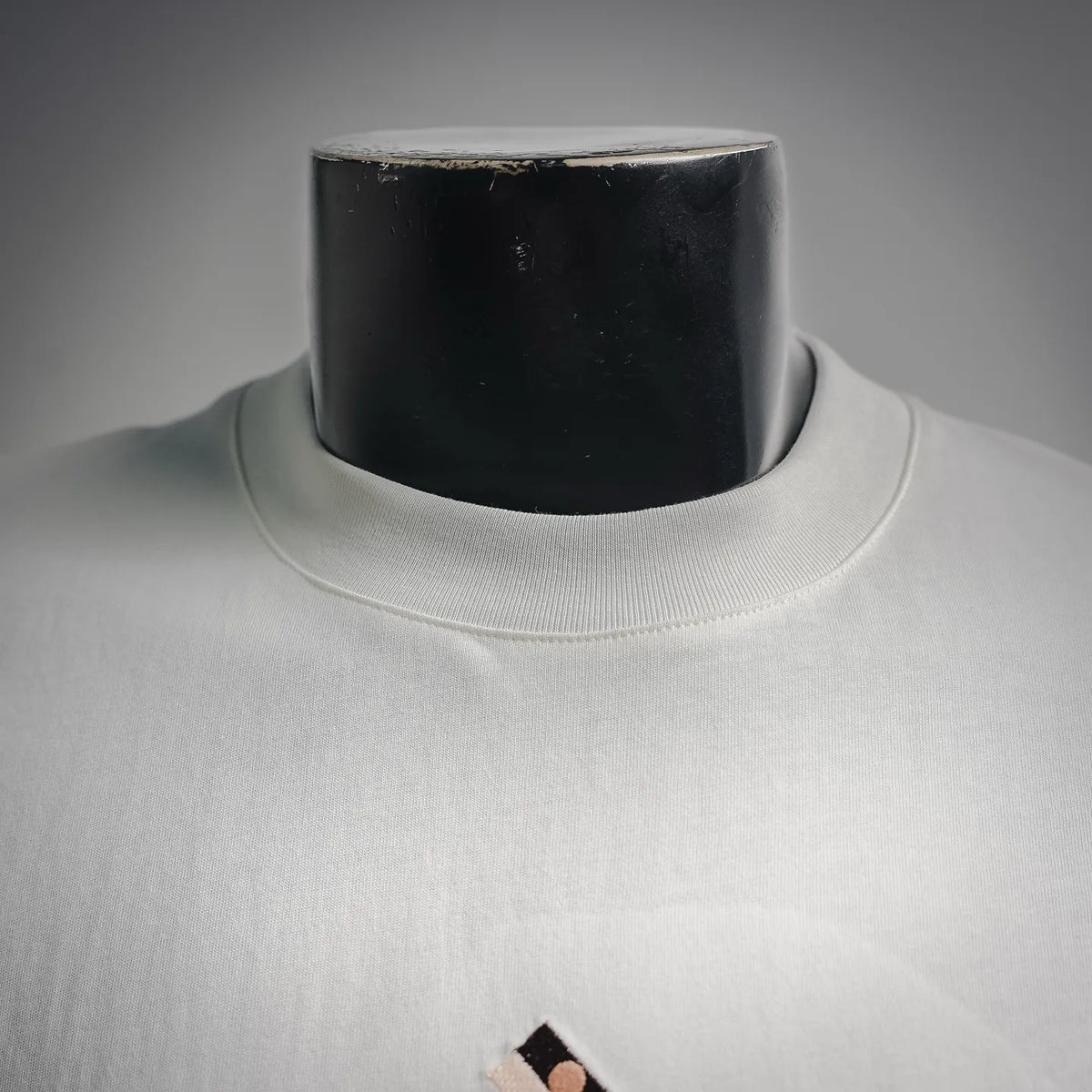 Fendi white crew-neck T-shirt close-up at neckline, ribbed collar