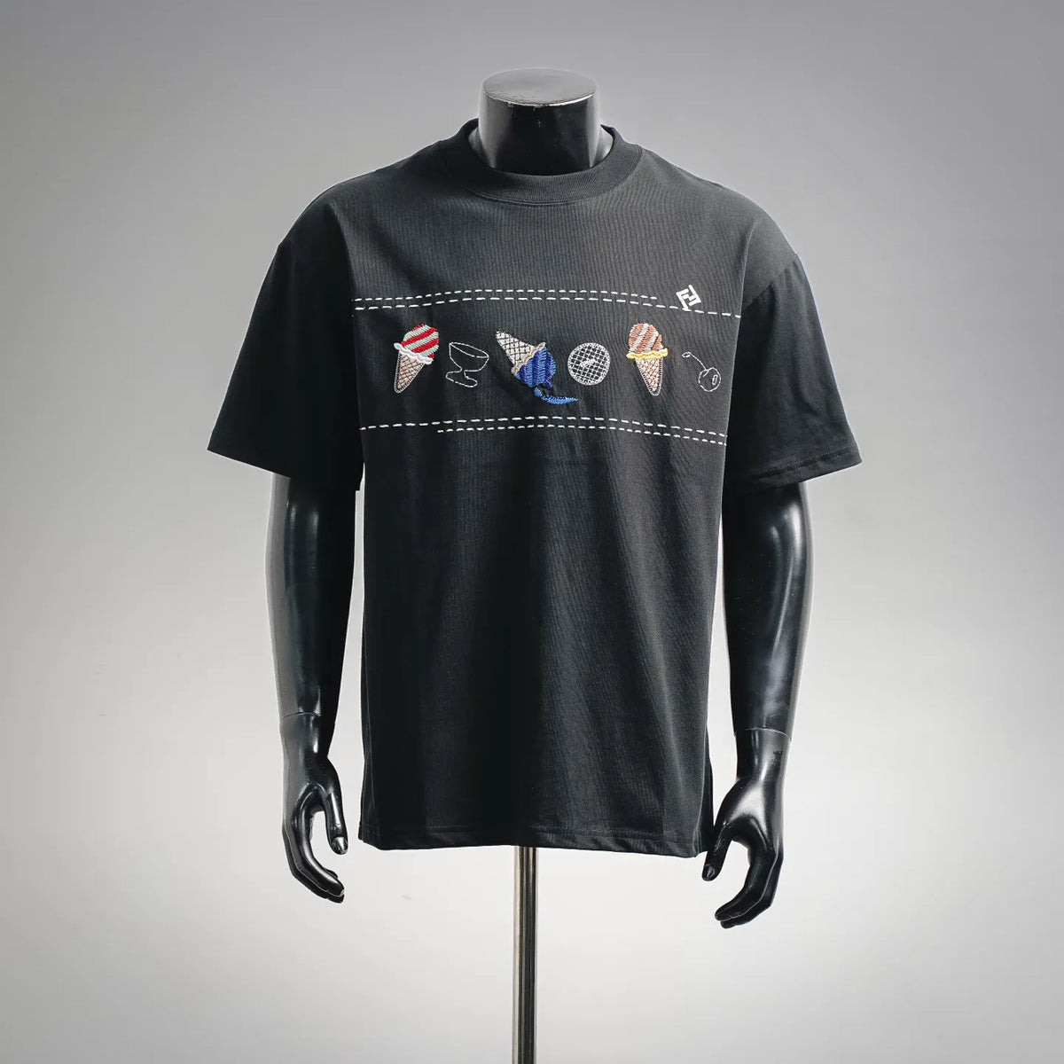 Black crew-neck T-shirt with colorful embroidered graphic across chest