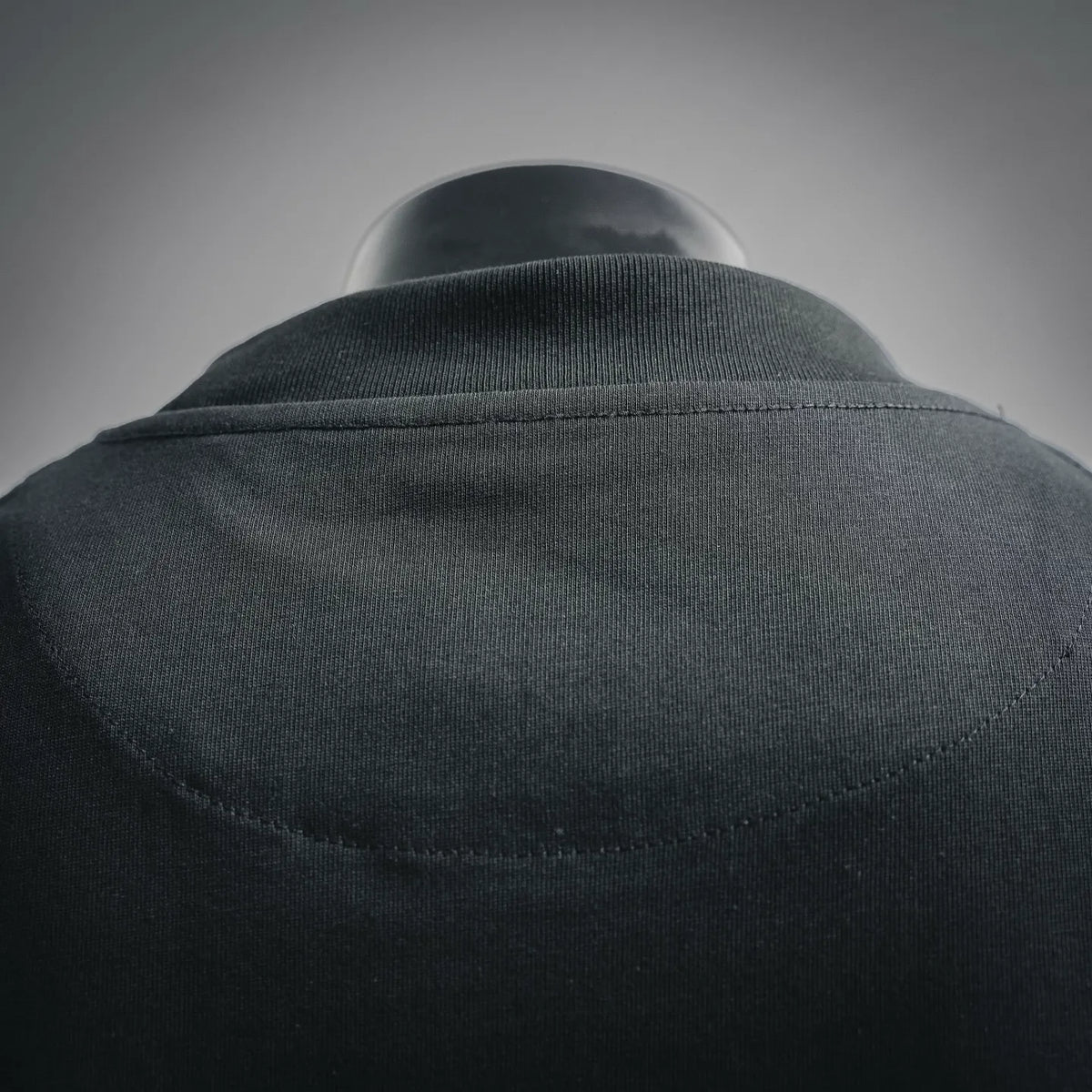 Black T-shirt back collar with seam detail at neckline