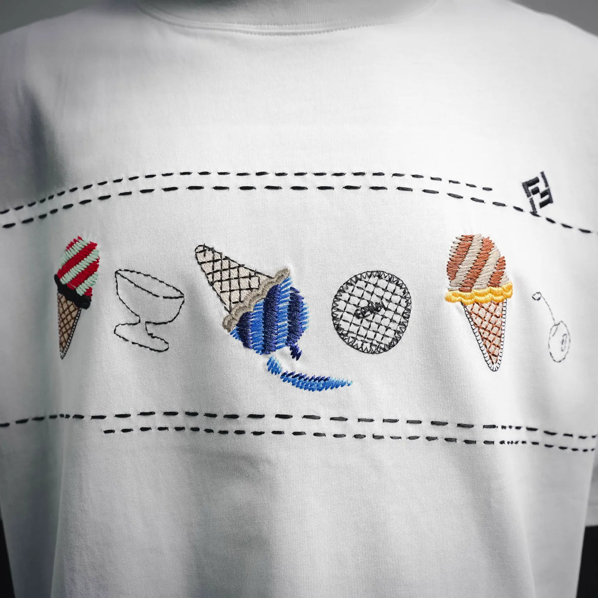 White crew-neck T-shirt with multicolor embroidered chest graphic