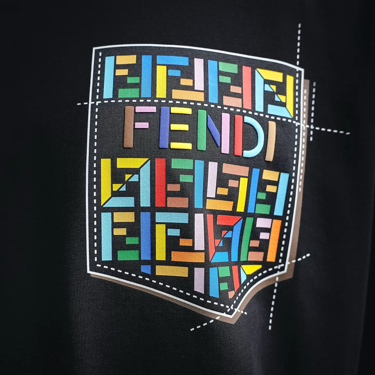Black T-shirt with large colorful Fendi logo graphic print on chest.