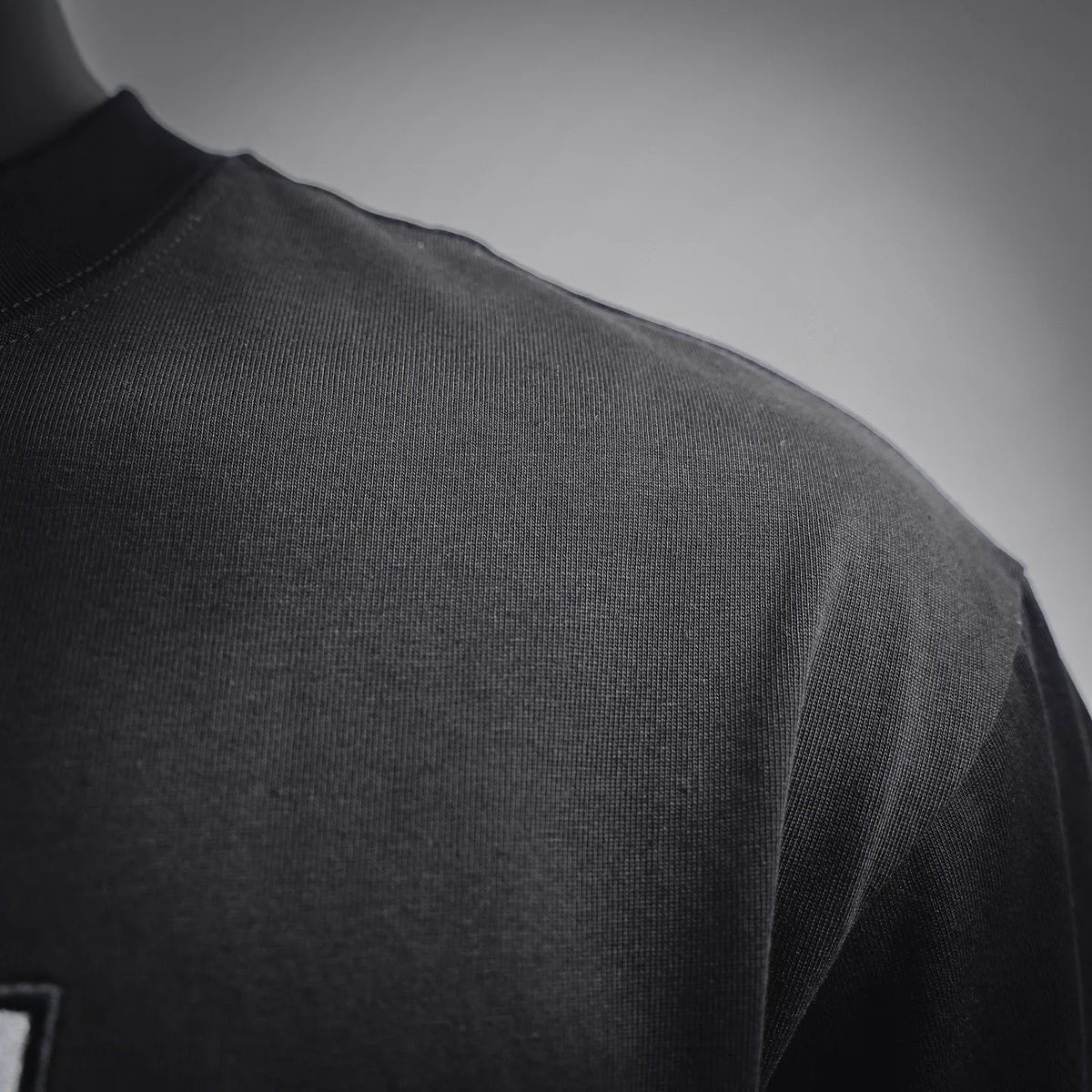 Black Fendi T-shirt close-up of the smooth fabric and side seam