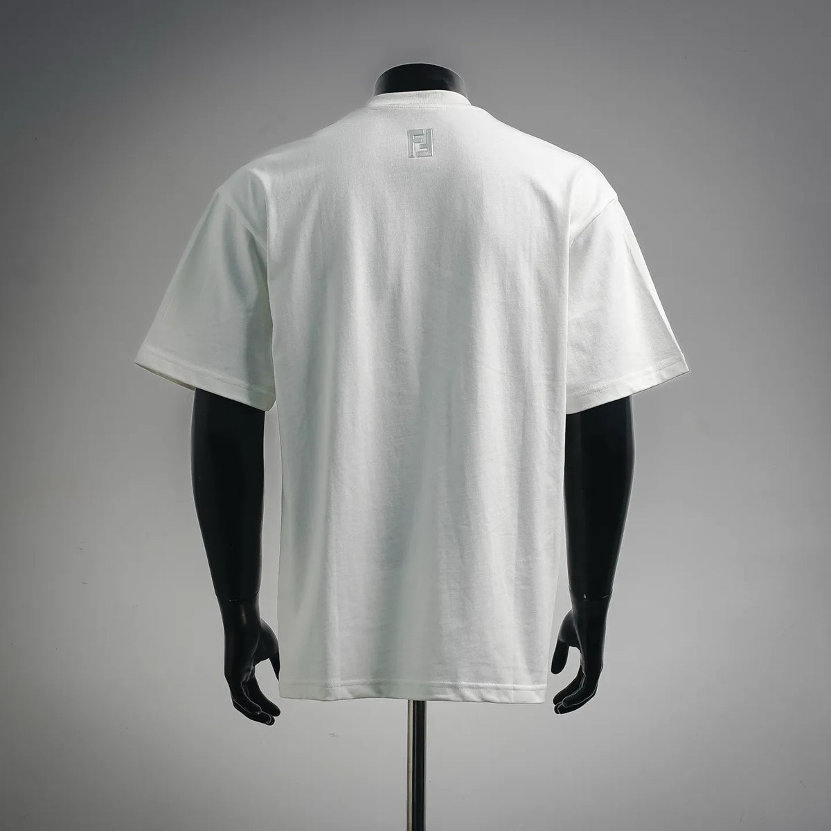White short-sleeve T-shirt with small Fendi logo on upper back