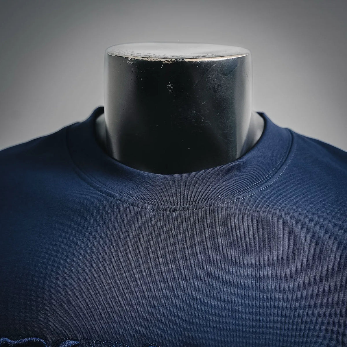 Navy blue crew-neck Fendi T-shirt neckline close-up on mannequin