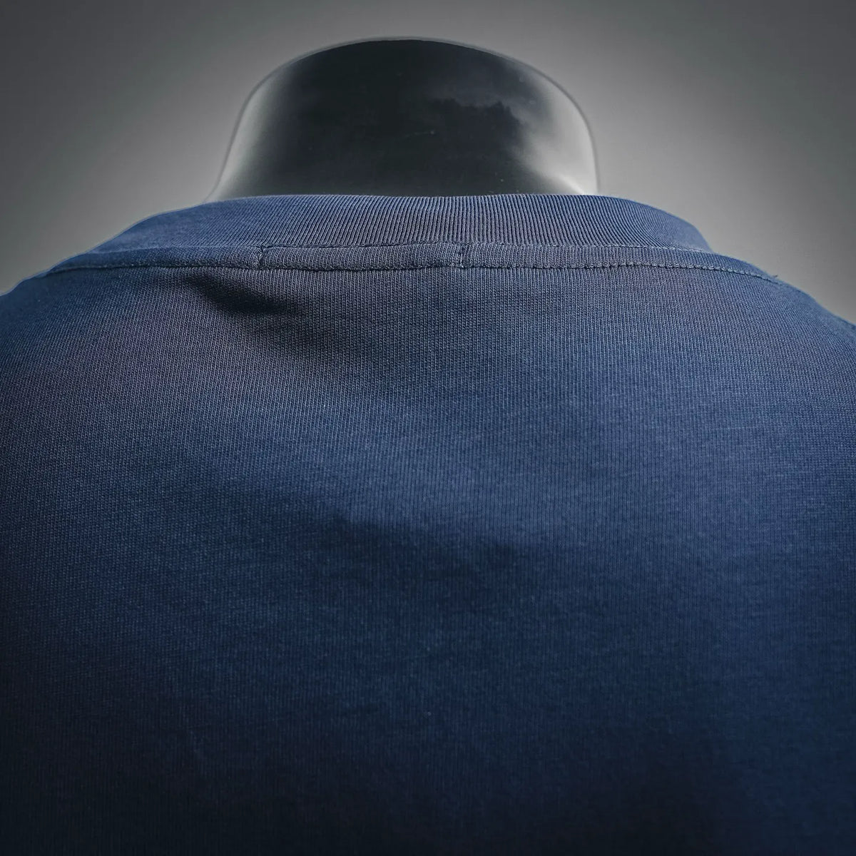 Navy blue crew-neck T-shirt back collar seam close-up