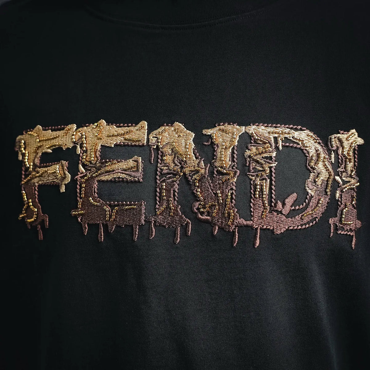 Black T-shirt with large gold FENDI logo embroidery detail