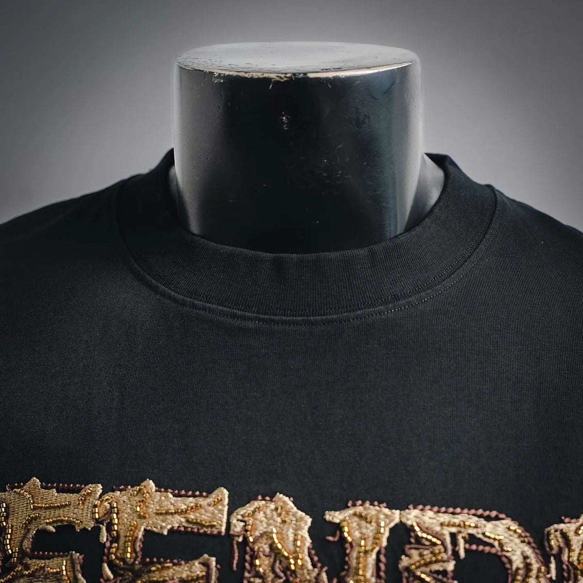Black Fendi short-sleeve T-shirt close-up of collar and embroidered logo
