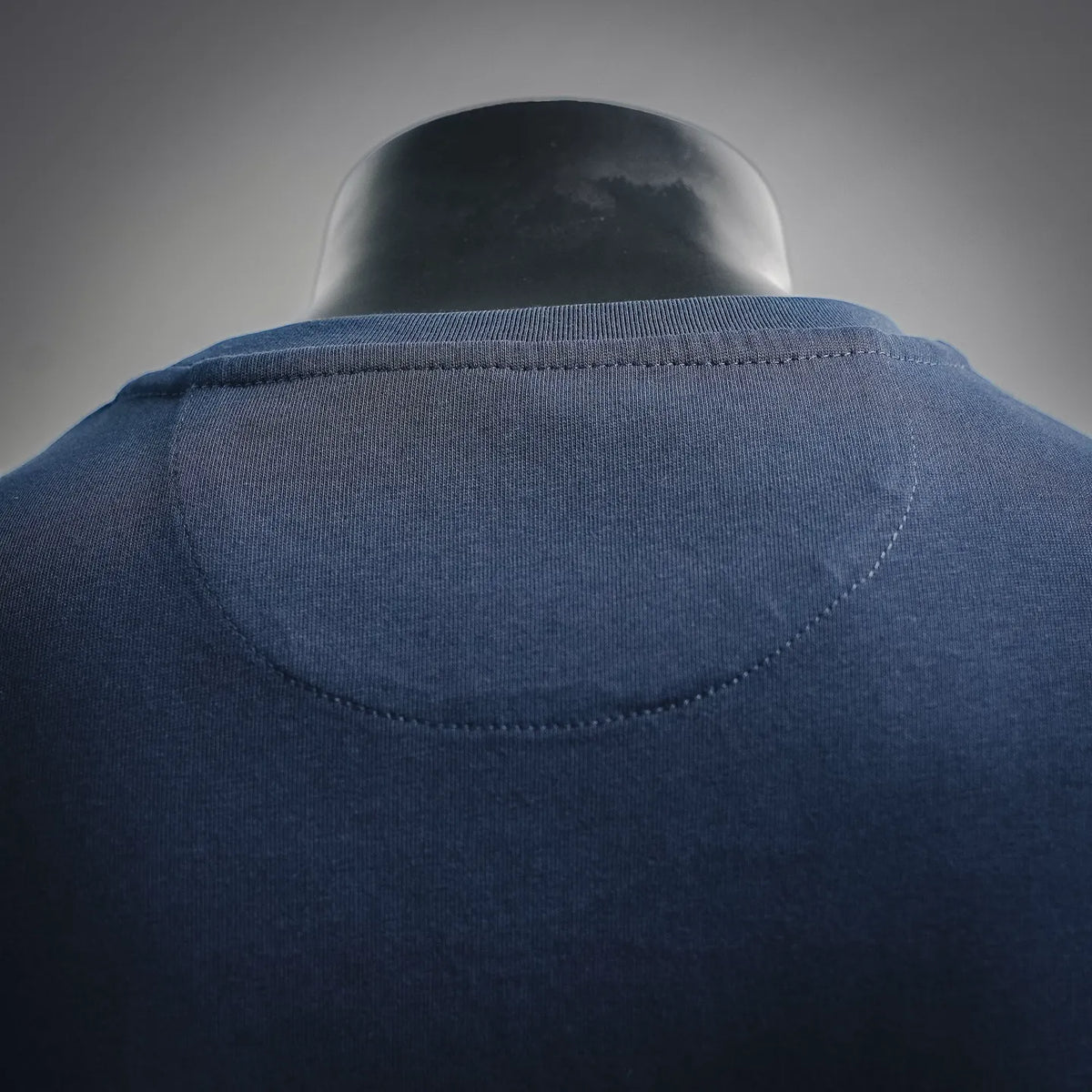 Back of navy crew-neck T-shirt with stitched neckline