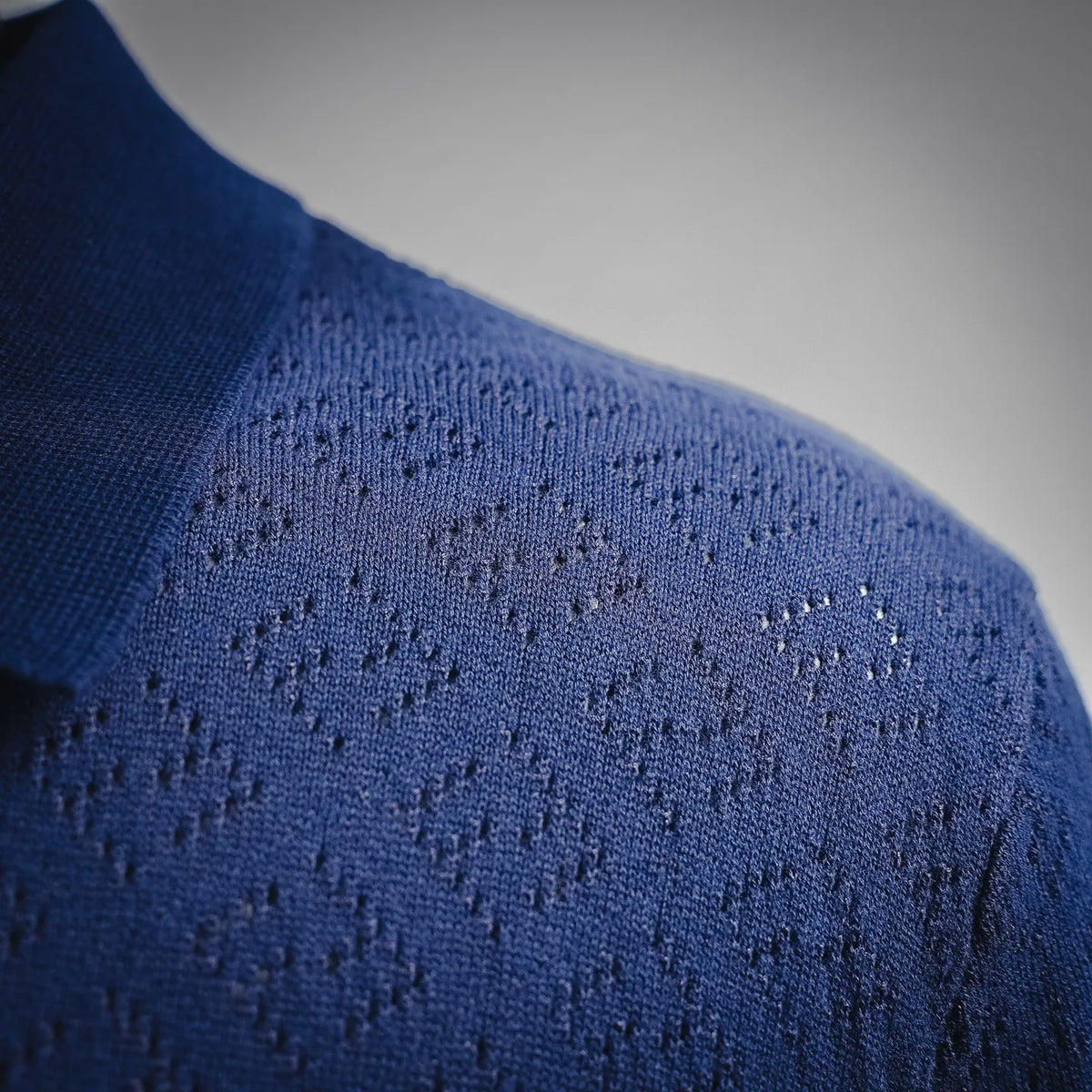 Fendi polo shirt close-up of deep blue knit texture with subtle pattern detail