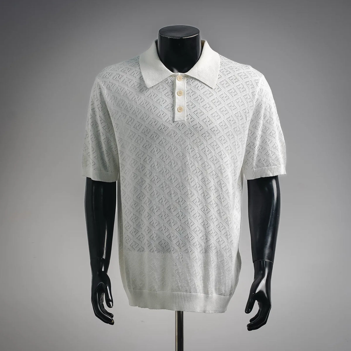 White short-sleeve polo shirt with ribbed collar and three-button placket.