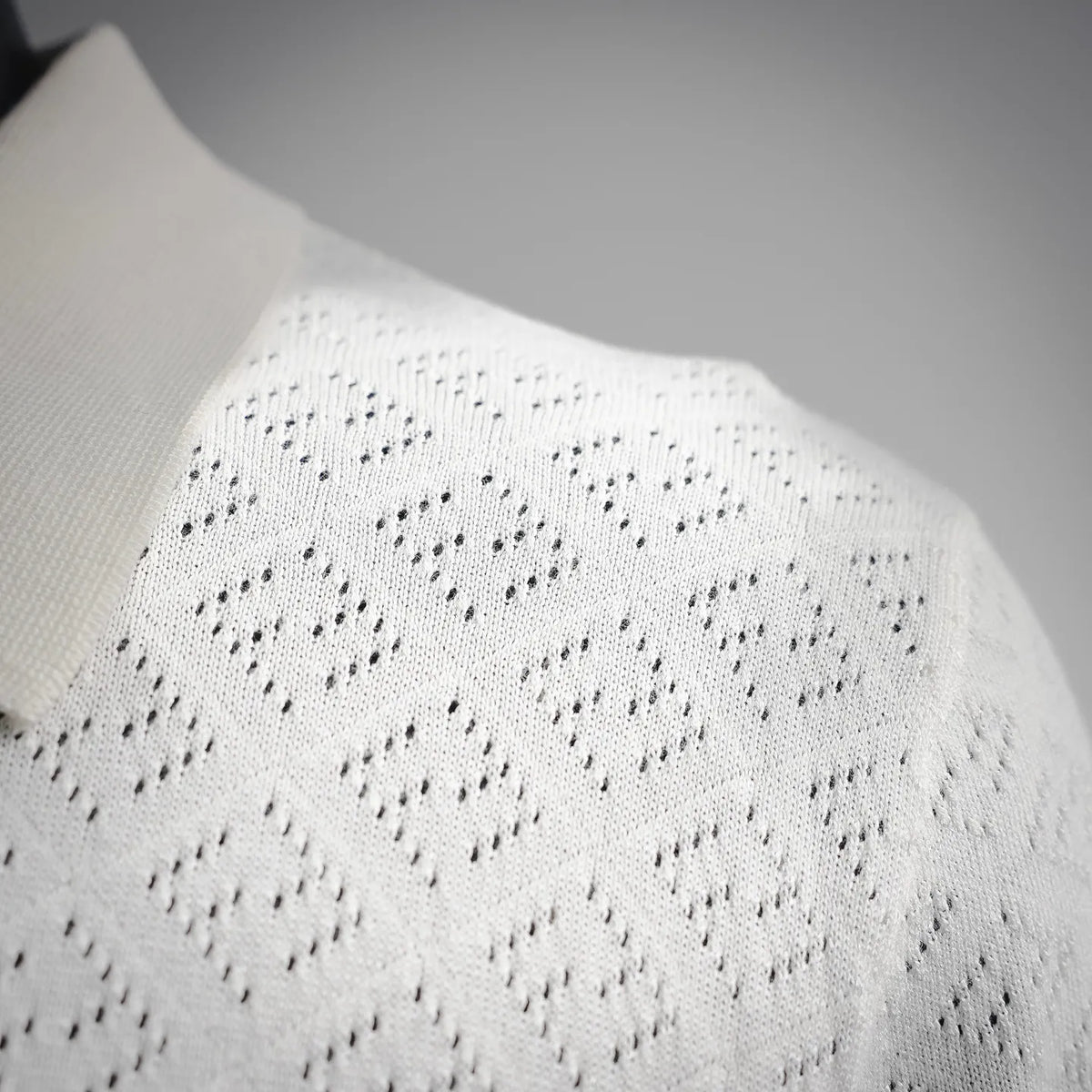 White diamond-pattern knit on the polo shoulder and upper back.