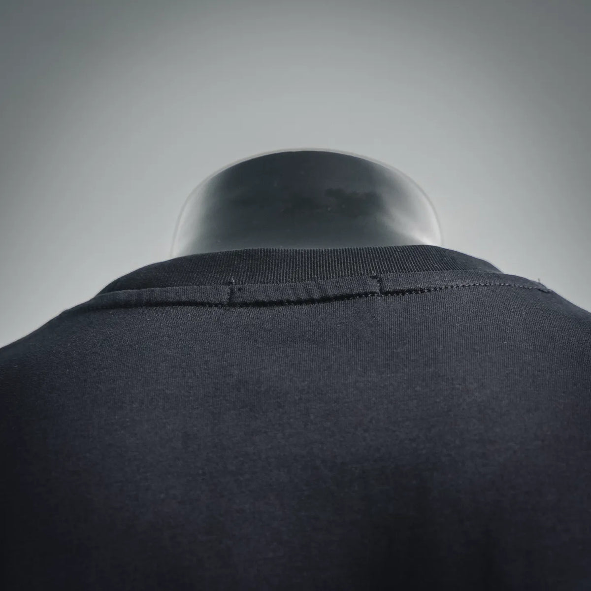 Black T-shirt collar and upper back, ribbed crew neckline