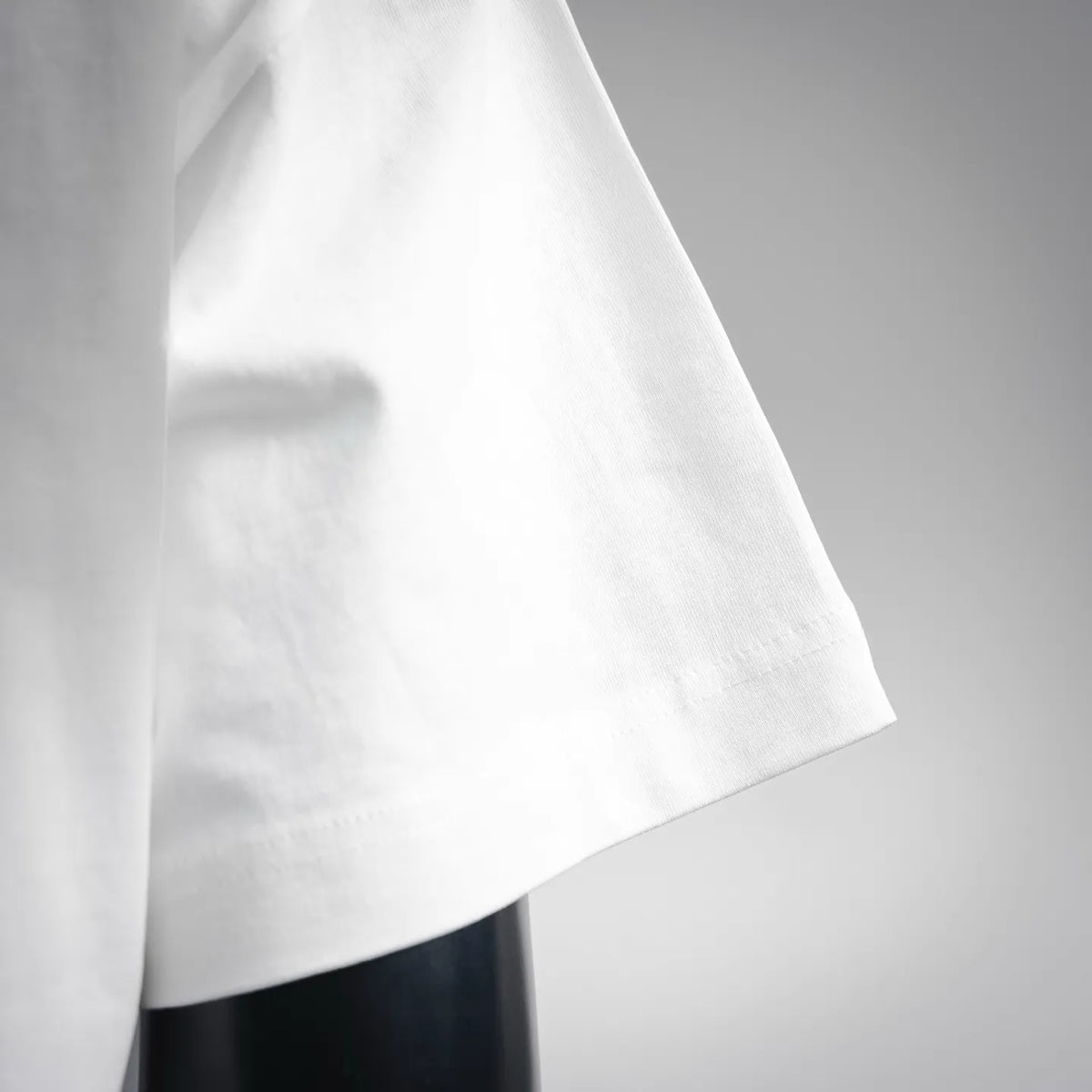 Fendi short-sleeve T-shirt, white fabric close-up of side seam and sleeve