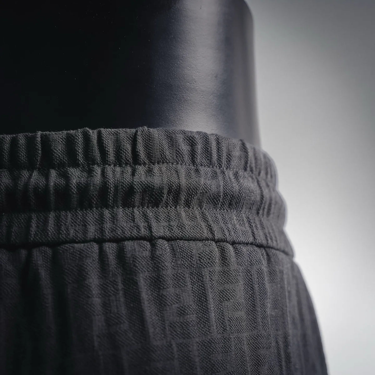 Black elastic waistband with ruched stitching on shorts