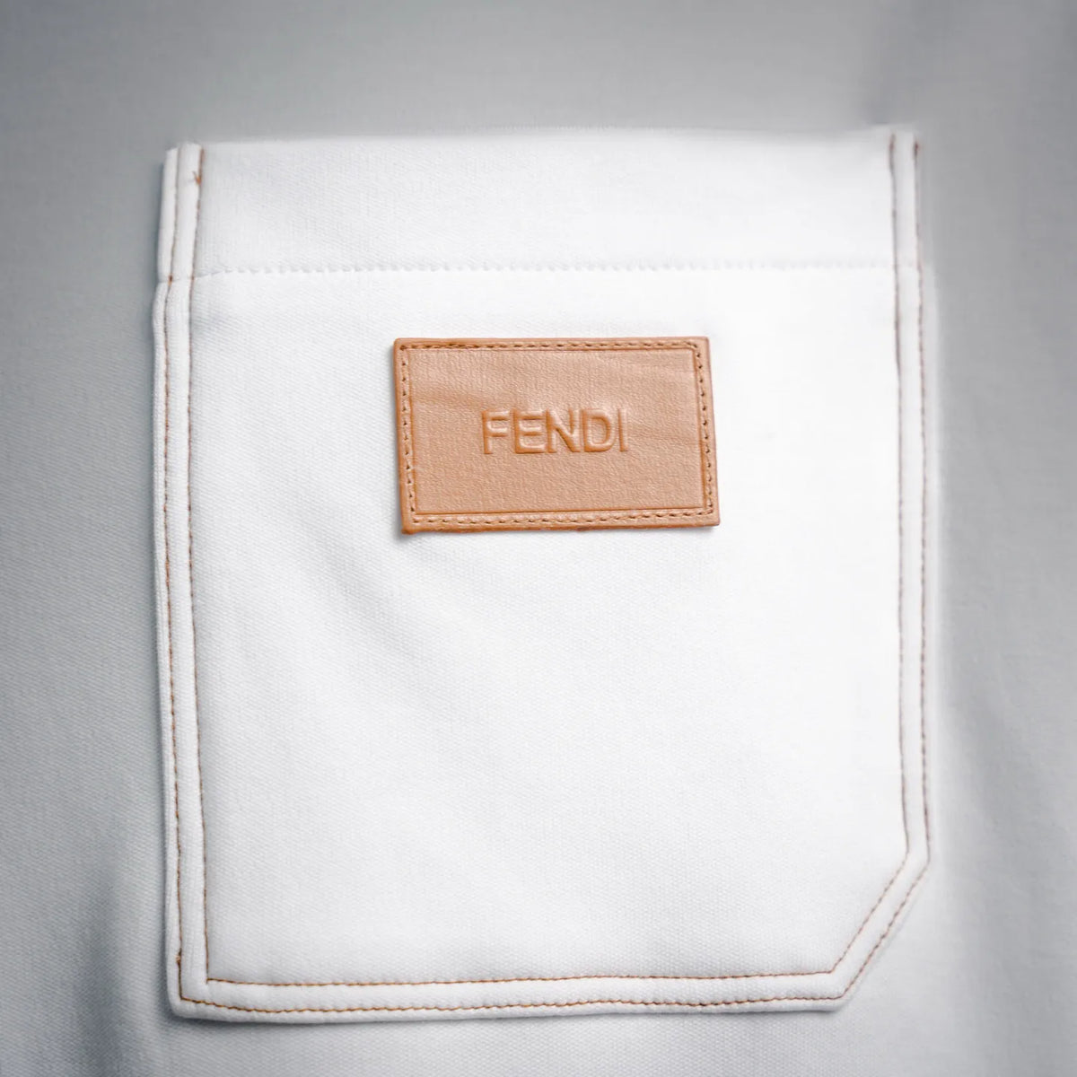 White T-shirt chest pocket with tan leather FENDI logo patch