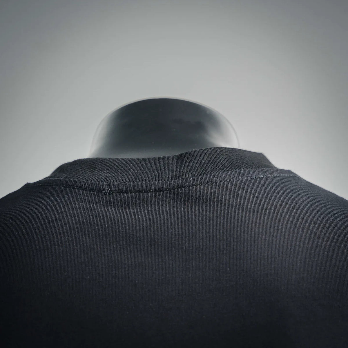 Dark crew-neck T-shirt with stitched neckline and collar seam