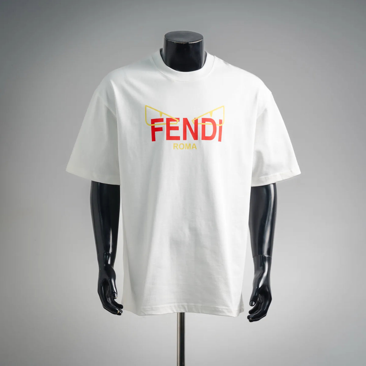 White Fendi short-sleeve T-shirt with multicolor “FENDI ROMA” logo on front.