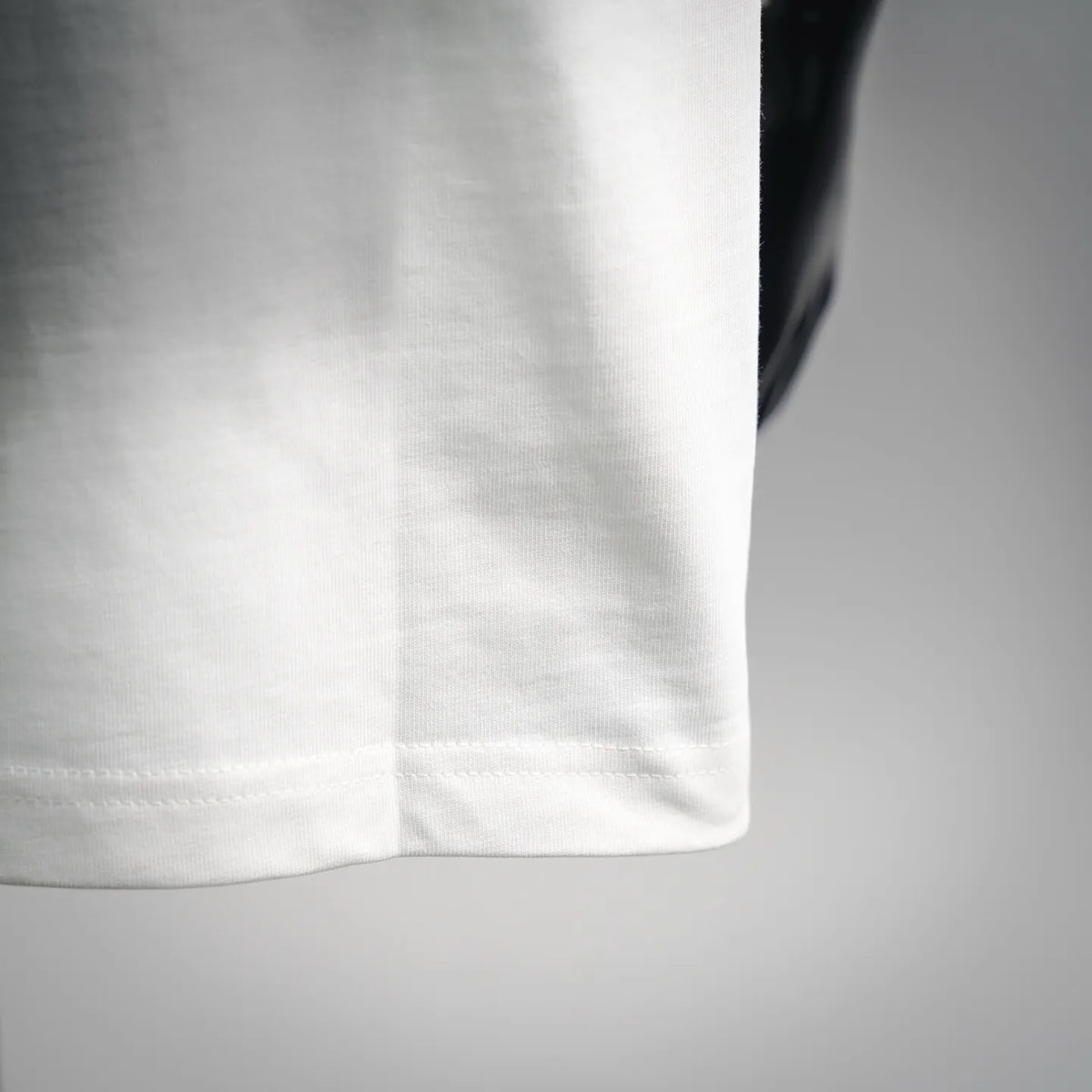 White Fendi T-shirt hem with visible stitching detail.