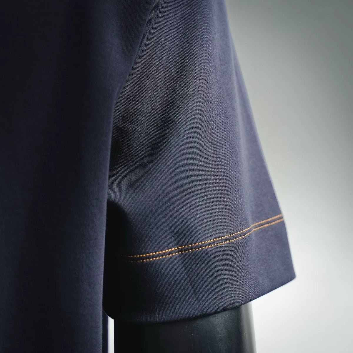 Fendi dark blue knit shirt hem with orange topstitch stripe on side
