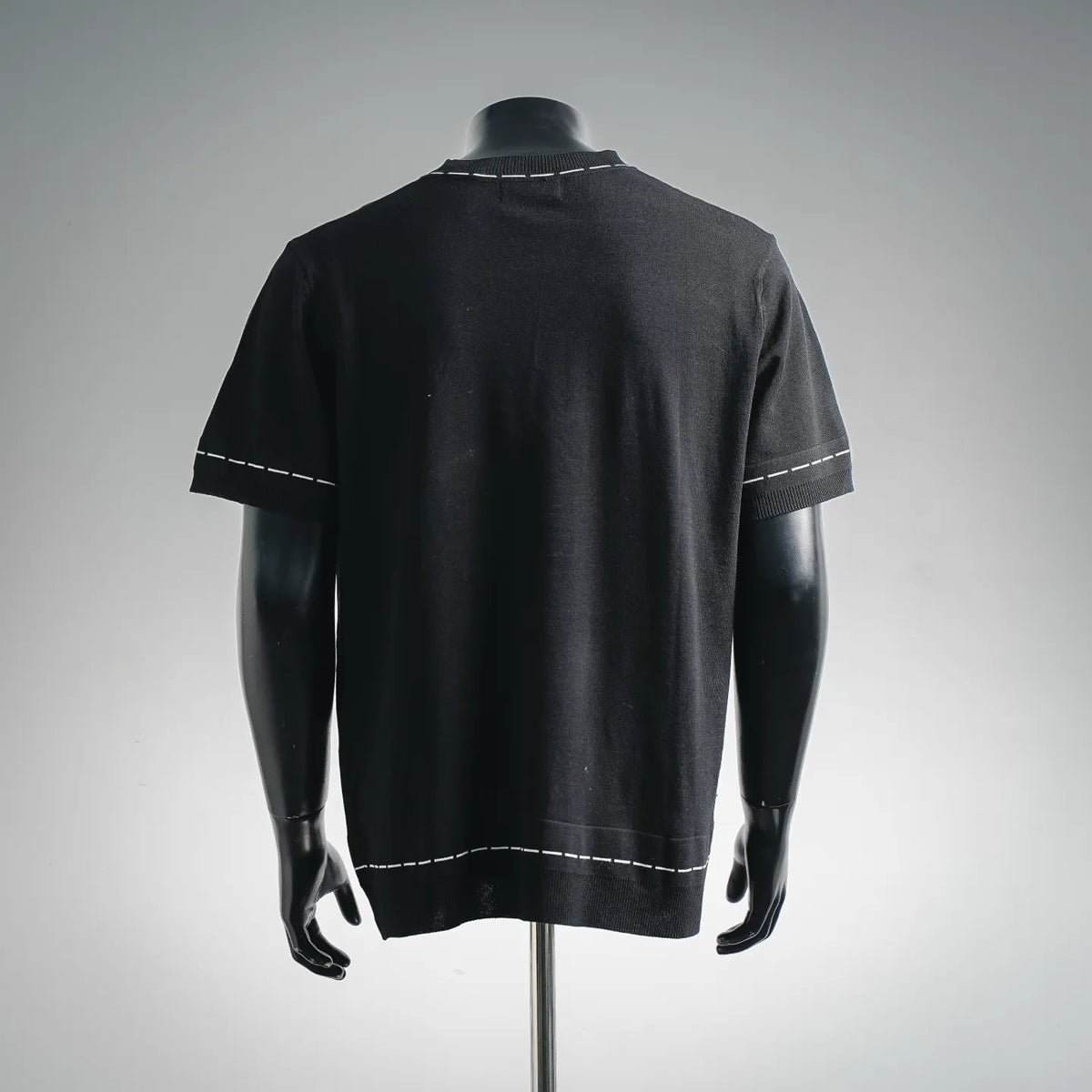 Fendi black knit T-shirt back view with white stitched trim along shoulders and hem
