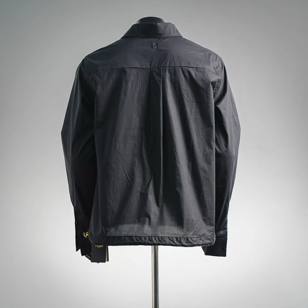 Black Fendi coat back view with center seam and buttoned sleeve cuffs