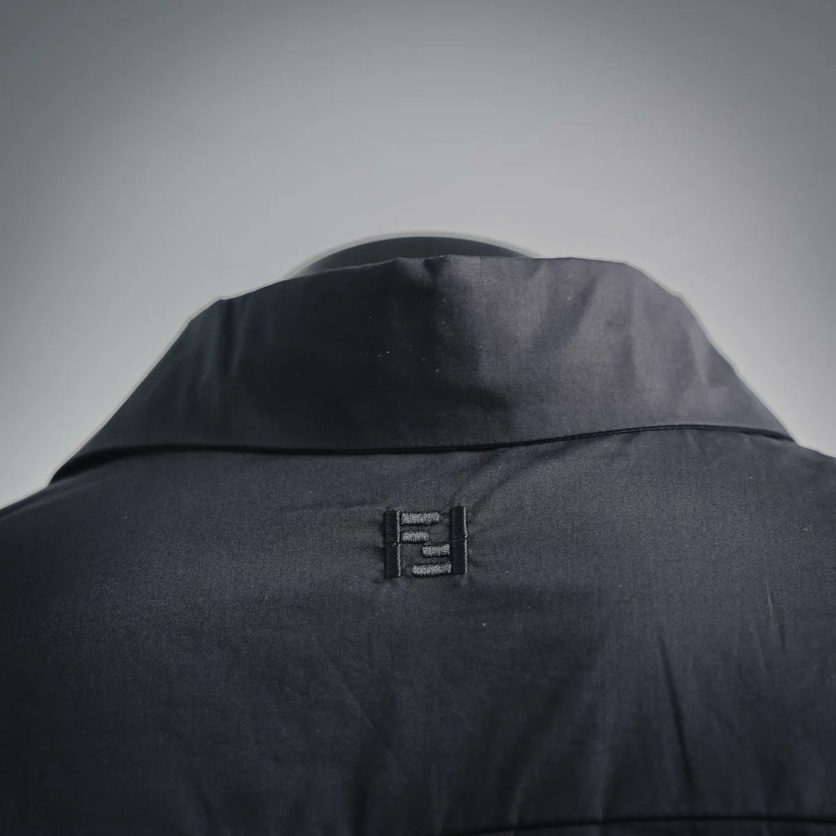 Black Fendi coat back yoke with small top closure detail