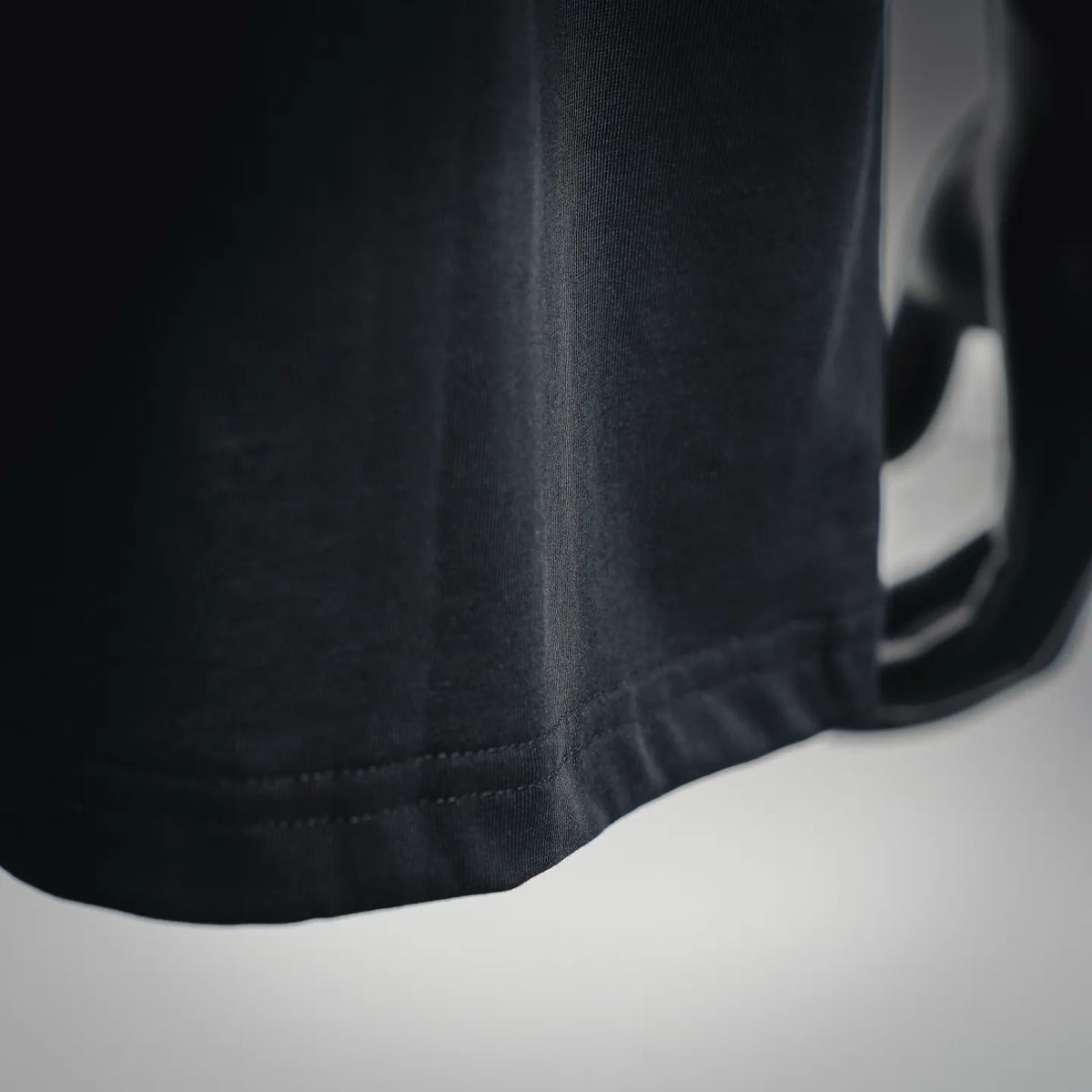 Black T-shirt hem with neat stitched edge