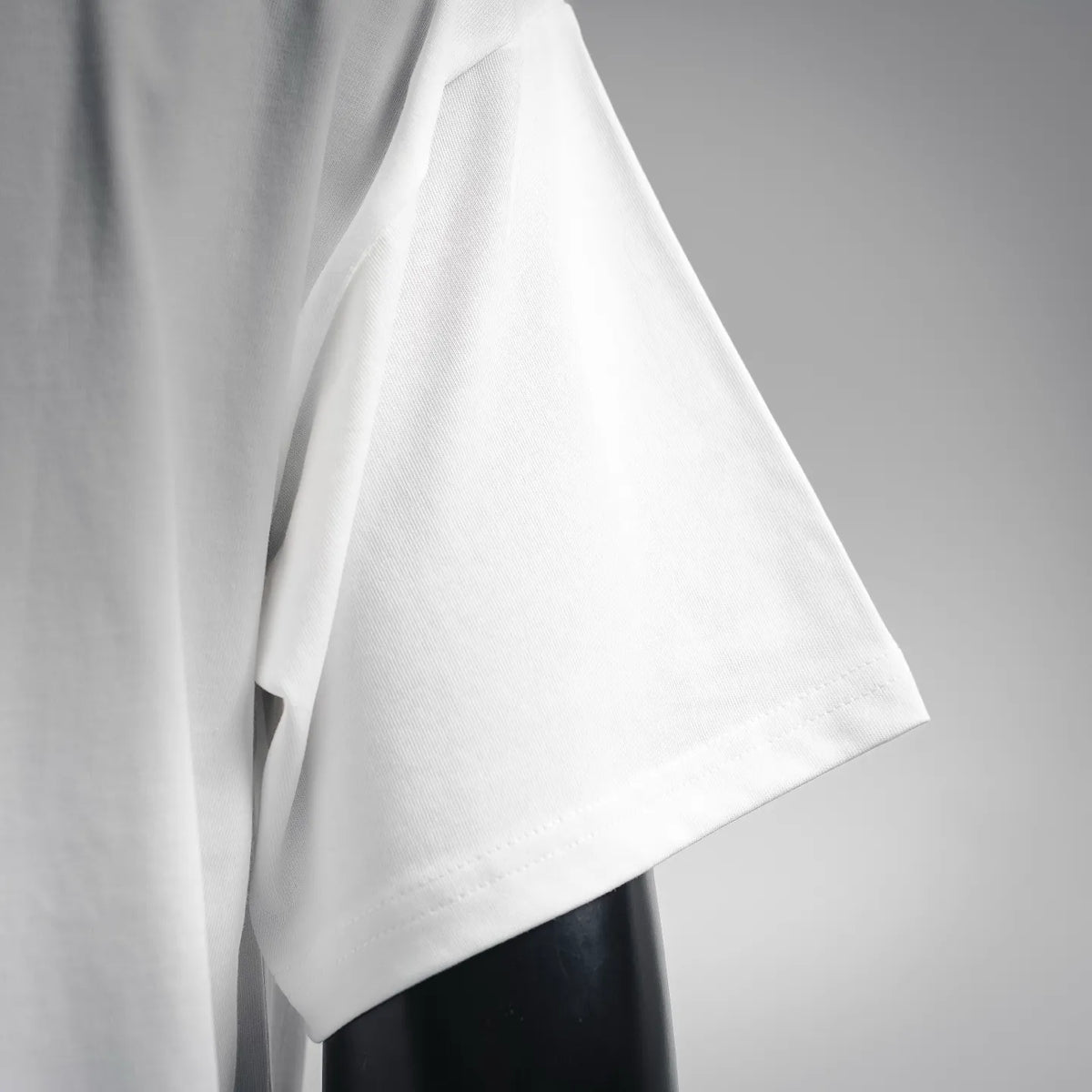 White T-shirt sleeve with soft drape and stitched hem