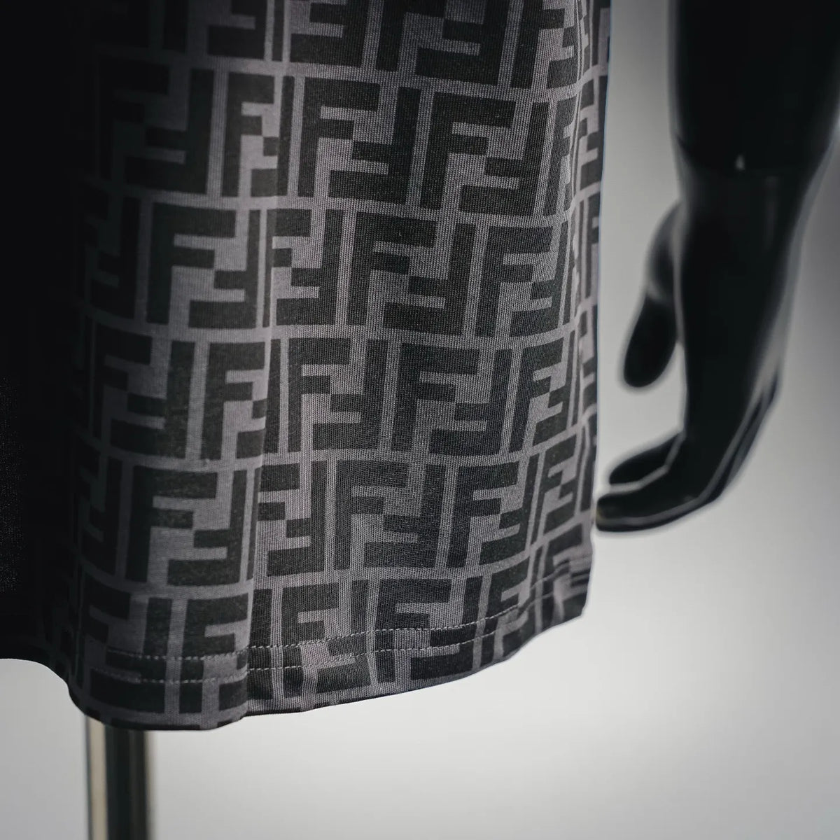 Fendi FF monogram T-shirt fabric close-up, black and gray geometric pattern