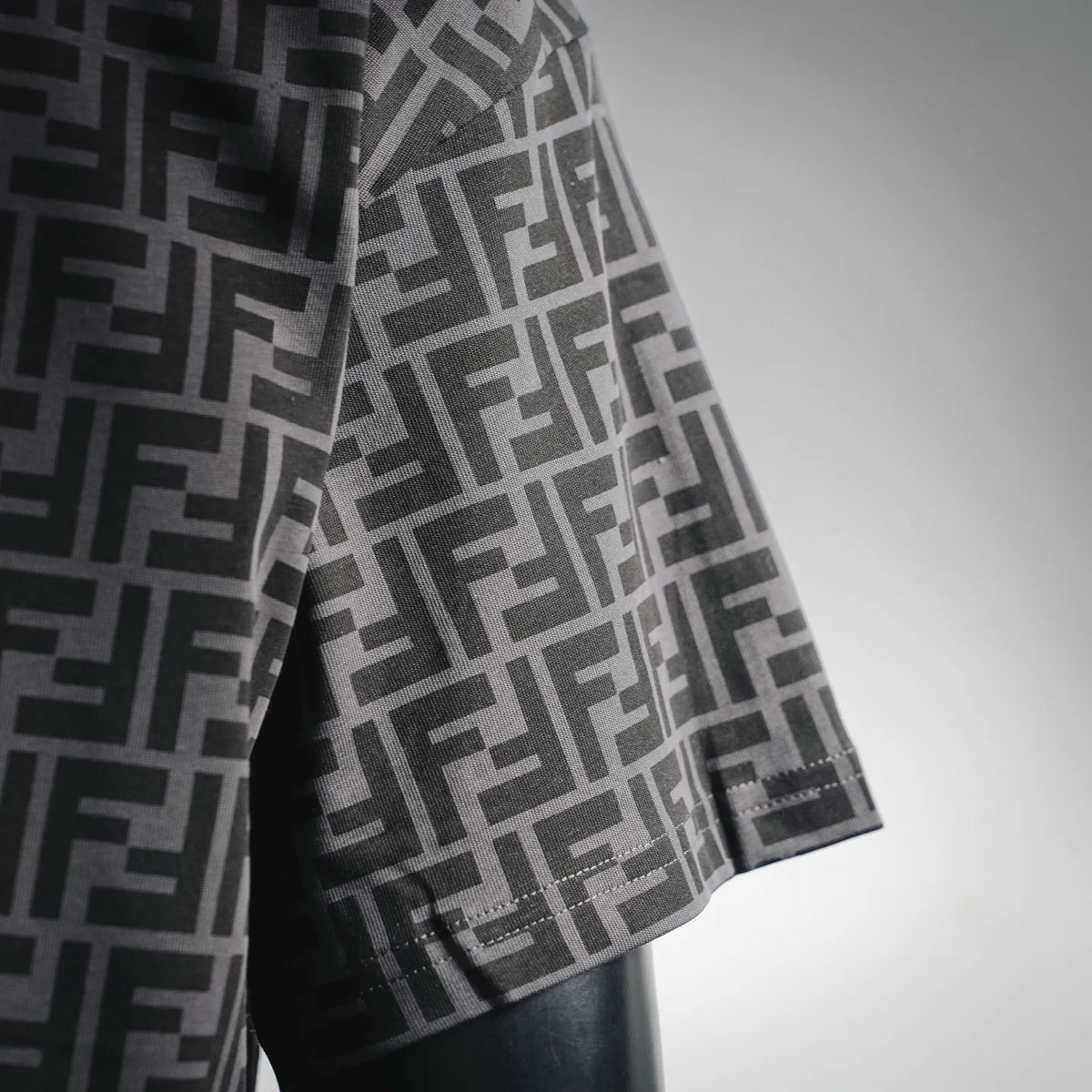 Fendi FF monogram T-shirt sleeve detail, black and gray with stitched hem and red trim