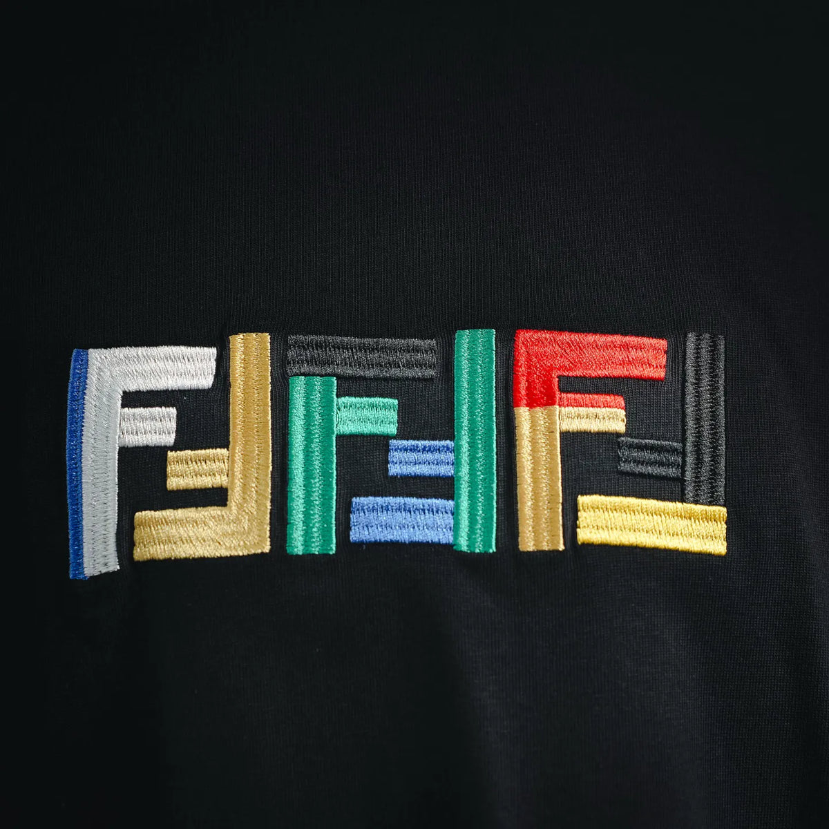 Black T-shirt chest logo embroidery in multicolor block letters