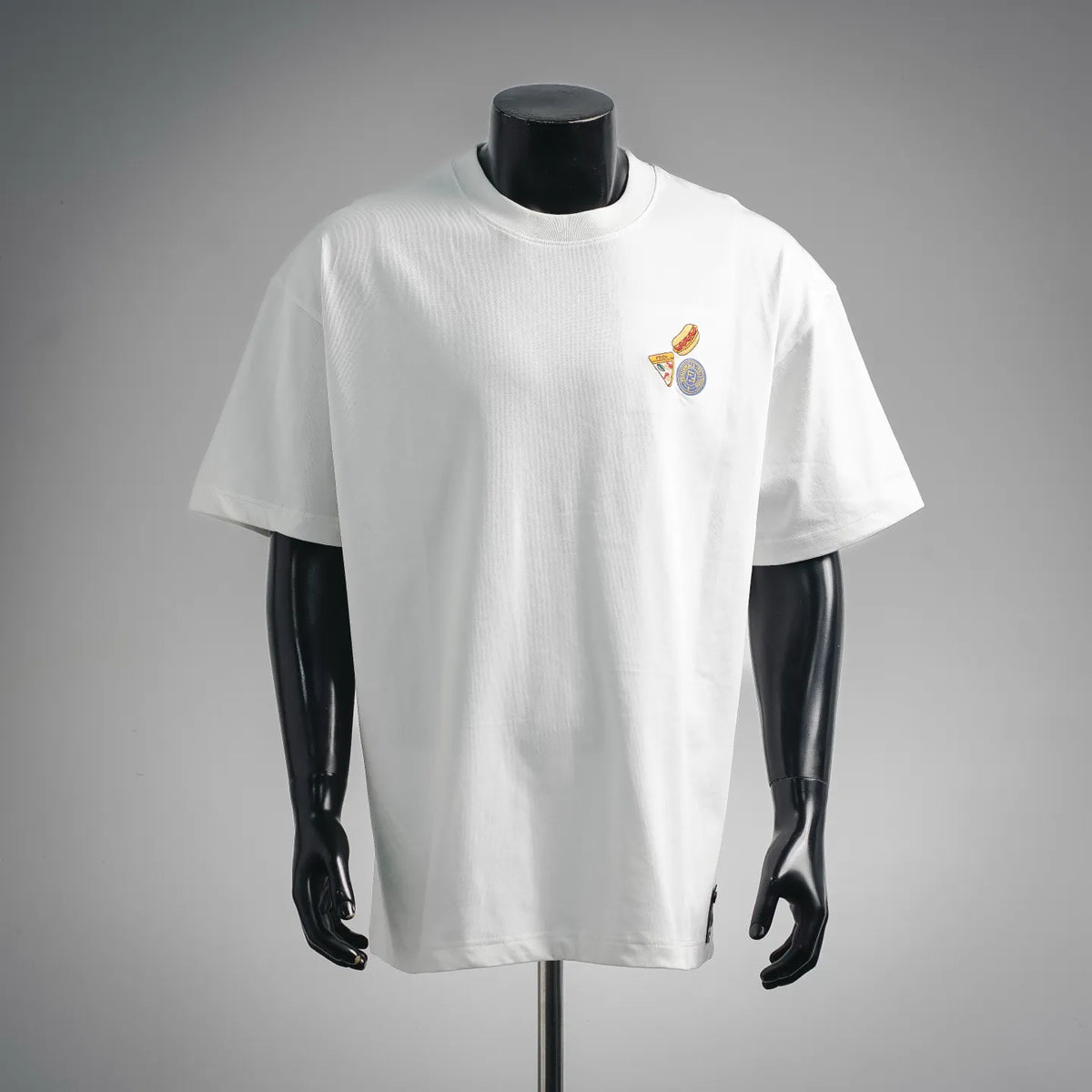 White crew-neck T-shirt with short sleeves and small Fendi logo patches on chest