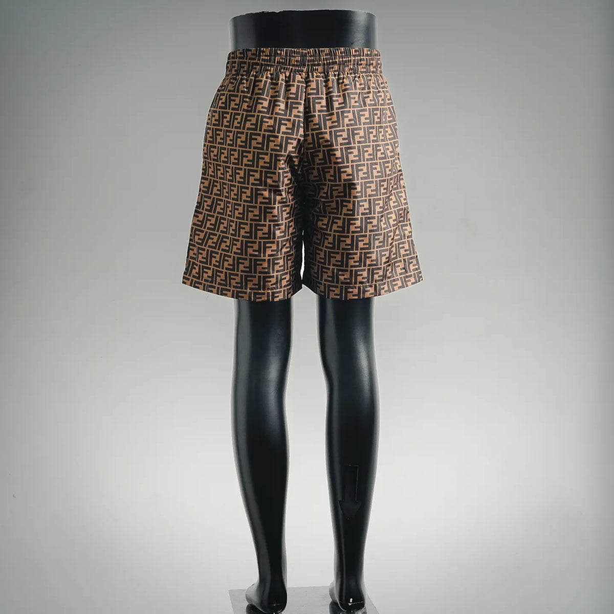 Back view of brown and black patterned drawstring shorts with elastic waistband