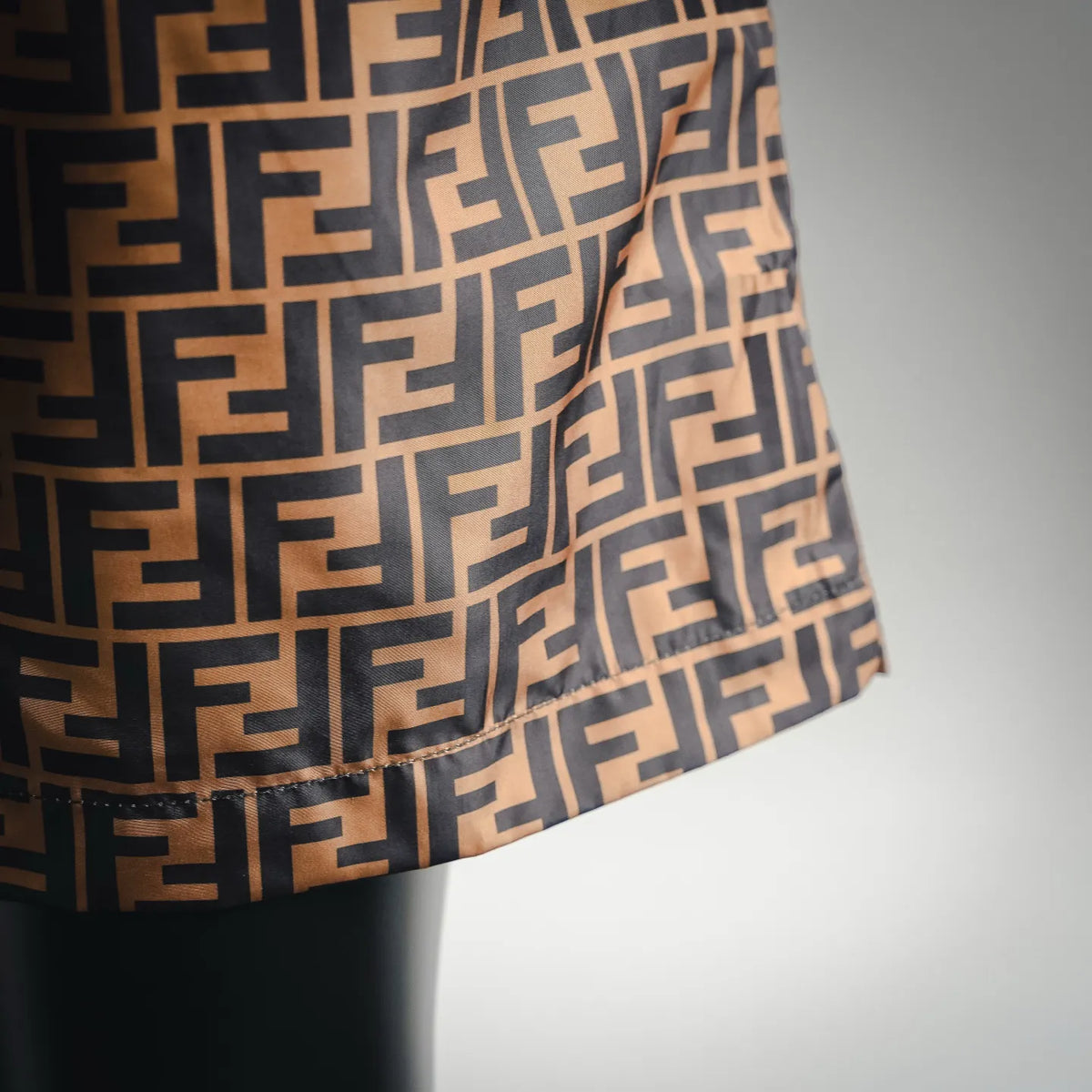 Side view of brown and black patterned shorts with gathered elastic hem