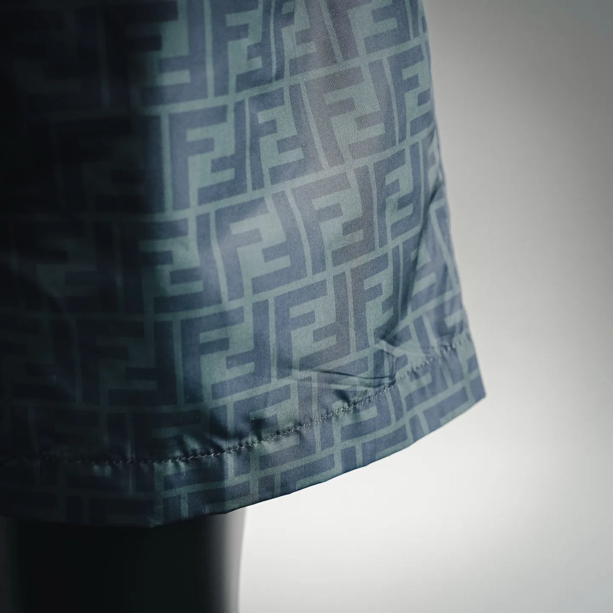 Fendi logo swim shorts with allover F pattern and stitched hem