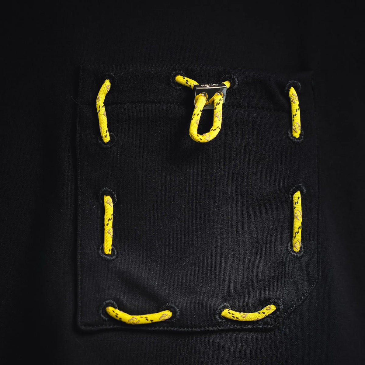 Fendi black chest pocket with yellow stitched hardware-style graphic