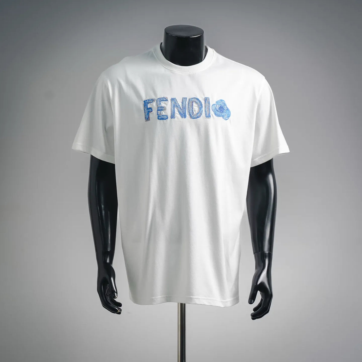 White short-sleeve T-shirt with blue FENDI logo on chest, crew neck.