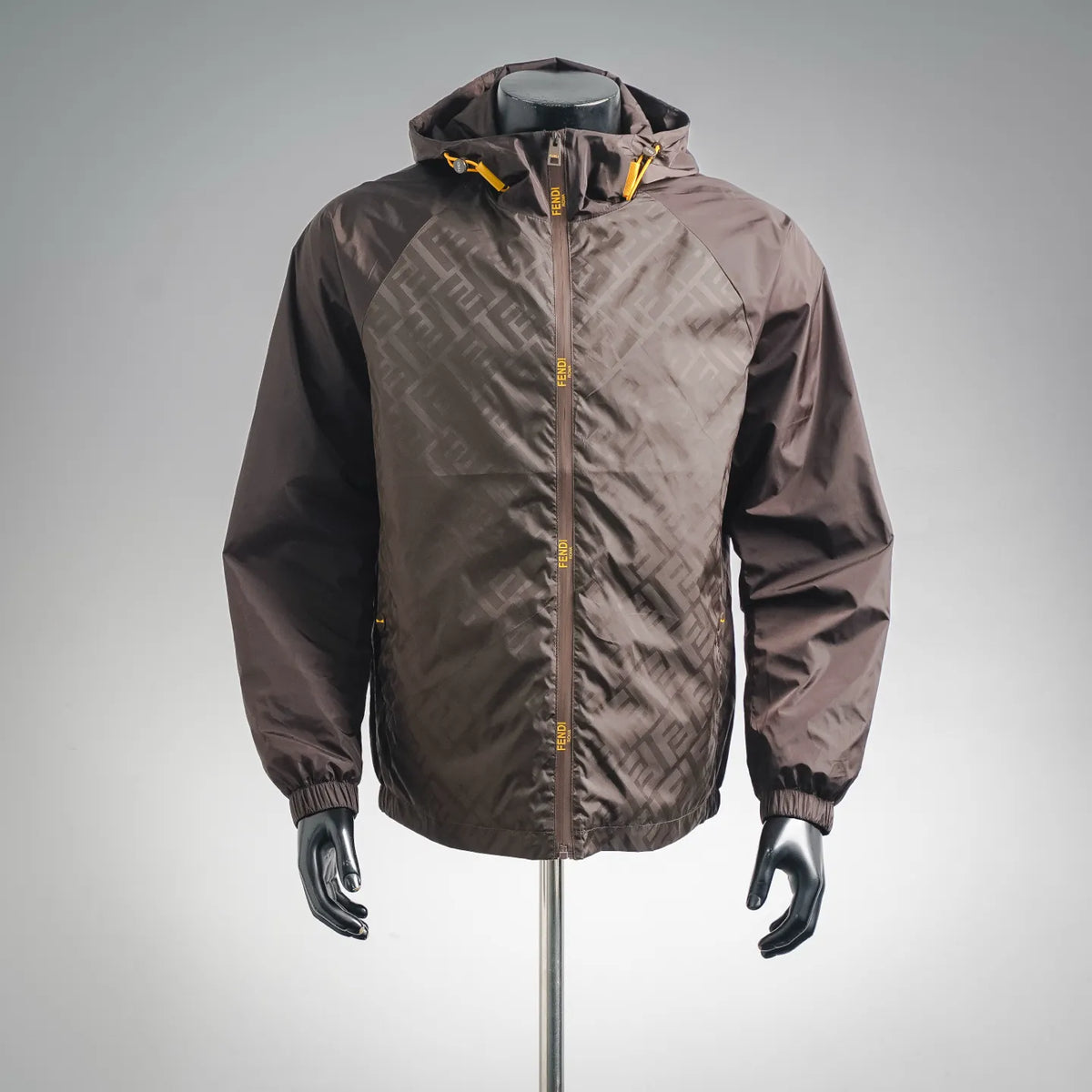 Dark brown hooded coat with FF logo pattern, full-zip front, yellow zipper accents
