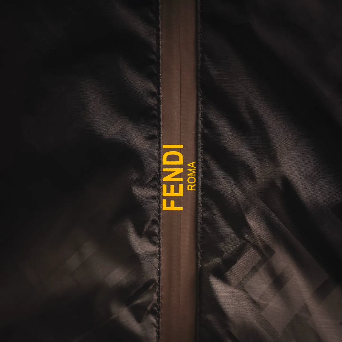 Inside placket with FENDI logo tape in yellow and black