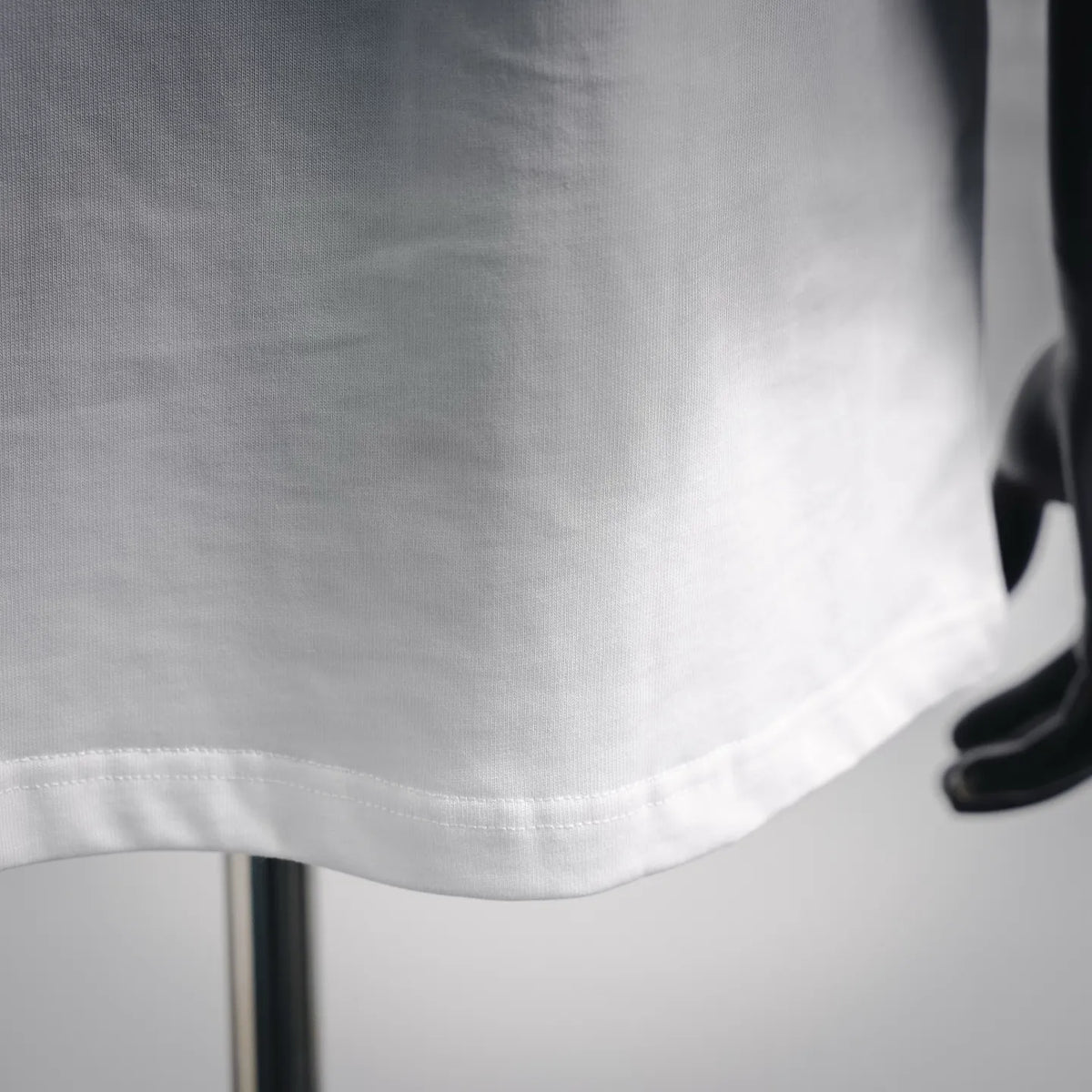 White T-shirt hem with visible stitching