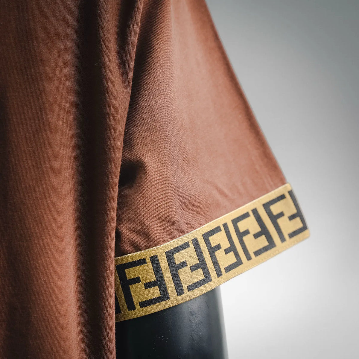 Rust brown sleeve cuff with Fendi FF pattern trim in gold and black